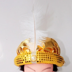 Detail of gold sequin elf hat featuring a white feather and pearl accent for party events