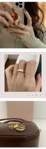 Detail view of double-layered gold ring set with white shell and octagonal zircon accents
