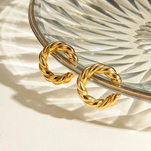 18K gold plated stainless steel twisted rope C-shaped hoop earrings on glass