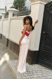 Detail of red and cream satin dress with lace embroidery and backless cutout design