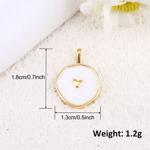 Detail of 18k gold-plated heart charm with dimensions 1.8cm x 1.3cm on textured background