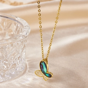 Elegant gold butterfly necklace featuring iridescent abalone shell and white zircon accents