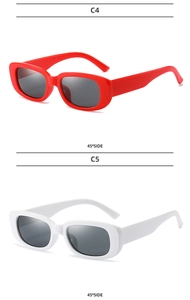 Detail view of red and white vintage narrow rectangular sunglasses at 45 degree angle