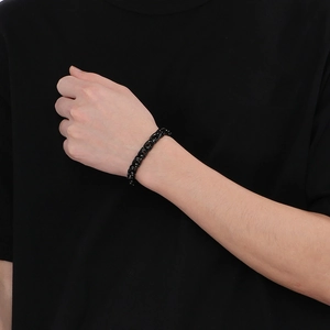 Close-up of 10mm black stainless steel basket weave chain bracelet worn on a wrist