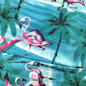 Macro shot of tropical flamingo and palm leaf print on durable twill canvas fabric