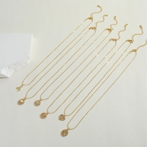 Close-up of assorted 14K gold plated heart and angel pendants with sparkling crystals