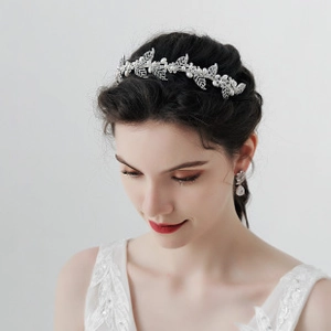 Detailed view of silver bridal headband with pearls and rhinestones on a female model