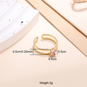 Close-up of 18K gold-plated ring with a square pink zircon on a minimalist background