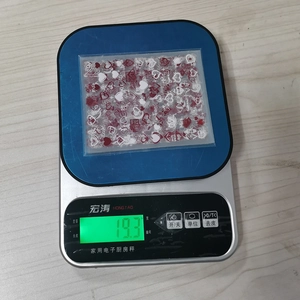 Detailed view of red heart nail stickers weighed at 19.3g on a scale for shipping info