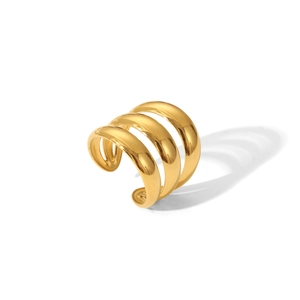 Detail of a triple-layered gold stainless steel open ring with a polished metallic finish