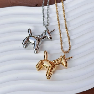 Artistic balloon unicorn pendant necklace in gold and silver mirror finish on white tray