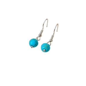 Ethnic turquoise beaded earrings with silver hooks on a clean white background
