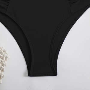 Detail of high-elastic black bikini bottom with double-needle stitching and knit texture