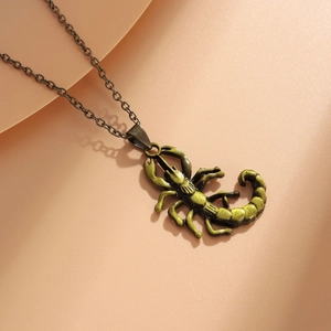 Close-up of a bronze scorpion pendant necklace with an antique finish on a soft background