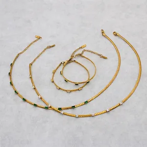Golden segment chain jewelry set with green and white rectangular gemstones and lobster clasp