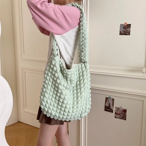 Detail view of light green popcorn fabric tote bag showing textured material and size