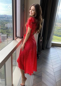 Detail of red polka dot midi dress showing flutter sleeves and back cutout design