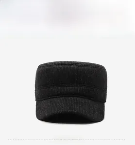 Detailed view of the dark grey textured fabric and mountain logo on the flat top cap