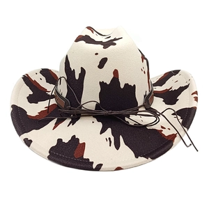 Detailed close-up of cow print felt cowboy hat with a brown leather hatband accent