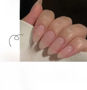 Detail of nude pink press-on nails with white 3D bows and sparkling micro rhinestones