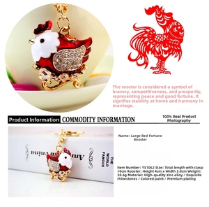 Detail view of red hen keychain with white crystals and golden zinc alloy plating
