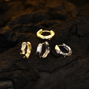 Irregular textured gold and silver hoop earrings with S925 stamp on dark wood