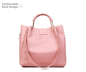 Rear view of a pink minimalist tote bag showing smooth texture and golden hardware