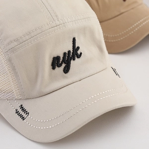 Beige NYK embroidered trucker hat with breathable mesh side panels for kids