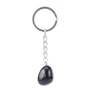 Macro detail of a polished black natural stone keychain with silver metal chain on white