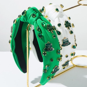 Detail of Irish headband with green rhinestones, clover charms and lucky hat decor