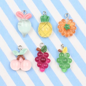 Detailed view of six colorful fruit and vegetable charms with smooth jelly texture