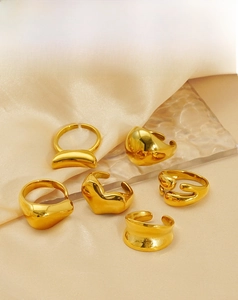 Detail of 18K gold plated stainless steel open rings with modern lava texture design
