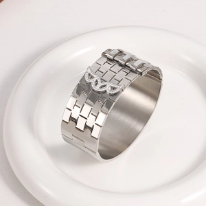 Silver vintage titanium steel wide bangle with 18K gold plated wing emblem and diamonds
