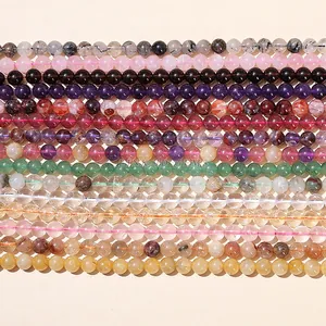 Macro view of natural crystal round beads including rose quartz and amethyst for DIY jewelry