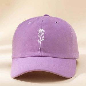 Detailed close-up of purple washed cotton baseball cap with white rose embroidery texture