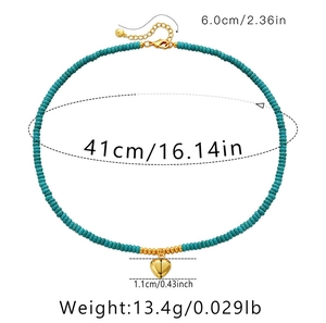 Detailed view of turquoise bead necklace with a golden heart pendant and size measurements