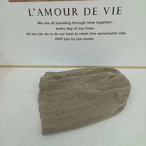 Brown cable knit slouchy beanie hat for winter with a soft vintage textured finish
