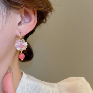 Detailed close-up of cherry blossom flower earrings with pink petals and white pearls