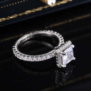 Macro view of 925 sterling silver ring showing the princess cut halo setting detail