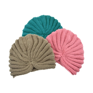Detail of soft knit turban hats in teal pink and tan with ribbed texture for babies