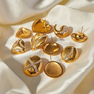 18k gold plated drop earrings set with crystals on silk background minimalist style