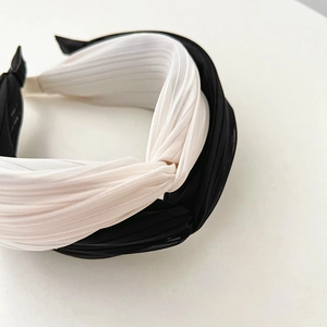 Elegant pleated twist headbands in black and white colors for a voluminous French style hair look
