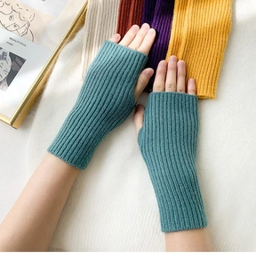 Detail of blue-grey knitted fingerless gloves with vertical ribbing texture and soft wool