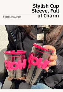 Detail of insulated glass tumblers with pink silicone sleeves and HOHOHO 3D text