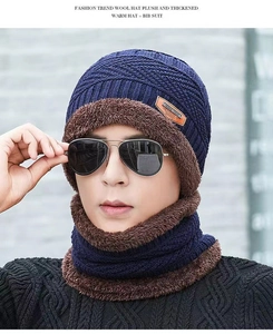 Close-up of navy blue winter knit hat and neck warmer with thick brown faux fleece lining