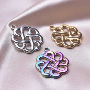 Detailed macro of Celtic witch knot pendants in gold, silver, and iridescent finishes