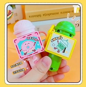 Detail of pink and green toy microphones with cute doughnut and drink illustrations