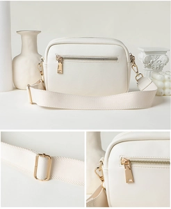 Detail of white crossbody bag featuring pebble leather texture and gold metal hardware