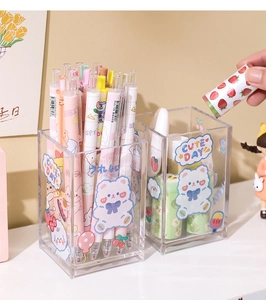 Close-up of clear acrylic desk organizer with cute bear stickers and colorful pens