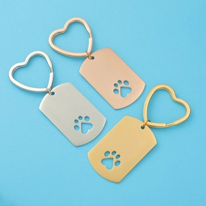 Hollow dog paw stainless steel keychains in silver, gold, and rose gold finishes